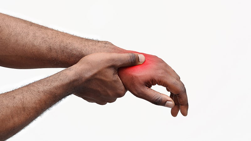 A man's wrist in pain caused by Rheumatoid Arthritis