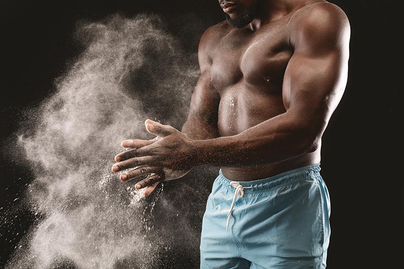 An athlete working out before using his infrared sauna