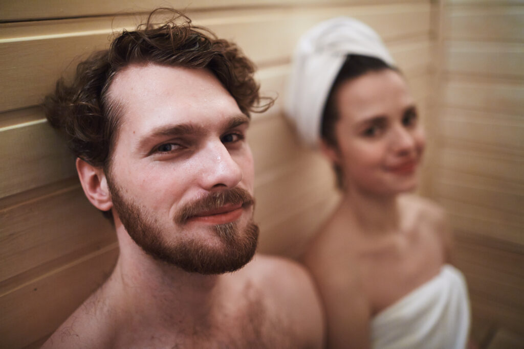 Couple detoxifying in  a sauna together